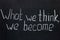 Chalkboard lettering `What we think, we become`