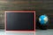 Chalkboard mock up frame and globe model on table