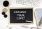 Chalkboard on office desk with text: Change your Life