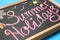 Chalkboard with phrase SUMMER HOLIDAYS on background, closeup. School`s out