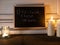 A chalkboard with reclaim the streets on the doorstep of a house with a small tea light and 2 pillar candles to show solidarity