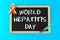 Chalkboard with text World Hepatitis Day. June 28th. Red yellow tape and syringe with blood on a blue background.