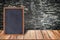 Chalkboard wood frame, blackboard sign menu on wooden table and brick wall background.