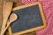 Chalkboard with wooden spoons on a red checkered tablecloth