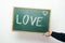 Chalkboard with the word LOVE handwritten in chalk