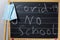 chalkboard with the words covid-19 no school and facemask in the corner