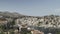 Chalki / Halki island, Greece: Pan shot of bright color houses with ceramic-tiled roofs and wooden windows constructed on rusty