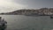 Chalki / Halki island, Greece - September 25, 2020: Pan shot of motor boat and cruise ship against greek inhabited island of