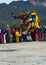 Cham dance , one lama dancer jumps incredible high , Bumthang , central Bhutan