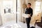 Chambermaid carrying fresh linen into a hotel bedroom