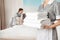 Chambermaid with stack of fresh towels in hotel room, closeup