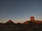 Chambers Pillar Central Australia at sunset with blue sky