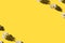 Chamomile creative border on yellow background. Top view.