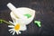 Chamomile flower and green phytotherapeutic capsules.