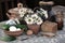 Chamomile flowers in a clay jug, bread, eggs, cucumbers in the form of a village still life on a table