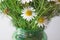Chamomile large bouquet in a transparent vase closeup with copy space for text. Natural cosmetics on a camomile basis for young