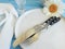 Chamomile, plate, fork, celebration knife banquet dinner summer catering on a blue wooden background