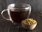 Chamomile Tea with a Bowl of Dried Chamomile Flowers on a Wooden Table