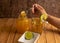 Chamomile tea, with chamomile flowers, in a clear glass cup with a metal tea diffuser, one side honey bee pot to sweeten the tea