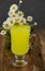 Chamomile tea in a glass cup on a wooden table. Bouquet of medicinal chamomile. Aromatherapy and herbal medicine. Daisies are