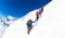 CHAMONIX, FRANCE - MARCH 19, 2016: a group of mountaineer climb a snowy peak. In background the glaciers and the summit of Mont Bl