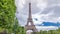 Champ de Mars and the Eiffel Tower timelapse hyperlapse in a sunny summer day. Paris, France