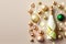 Champagne bottle with golden christmas balls and ribbons on beige background. Copy Space. Generative AI