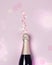 Champagne Bottle on Pink Background Minimal Party Holiday Concept Festive Top View Drawing Lights