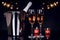 Champagne bottle, two wine glasses and candles with lights