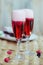 Champagne cocktails with raspberries for a romantic evening on a wooden table. Pink liquid color, glasses with bubbles