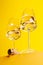 Champagne elegance: Glasses with sparkling wine against a vibrant yellow background