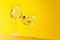 Champagne elegance: Glasses with sparkling wine against a vibrant yellow background