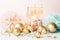 Champagne in glass goblets gold balloons stars serpentine a pastel delicate pink background. New year festive concept.