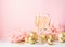 Champagne in glass goblets gold balloons stars serpentine a pastel delicate pink background. New year festive concept.