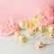 Champagne in glass goblets gold balloons stars serpentine a pastel delicate pink background. New year festive concept.