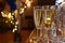 Champagne glasses on a bar offset with fairy lights