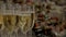 Champagne glasses stand in rows on a table with snacks