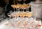 Champagne glasses standing in a tower at the wedding party. Champagne glass pyramid. Pyramid of glasses of wine, champagne, tower