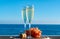 Champagne, prosecco or cava served with pink grape in two glasses on outside terrace with sea view