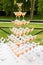 Champagne slide. Pyramid or fountain made of champagne glasses with cherry and steam from dry ice
