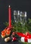 Champagne, wine sparkling, red candle, tartlets with red caviar, gift box with red ribbon , fir  on a black