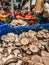 champignon mushrooms on the counter in the store next to other vegetables. fresh vegetables in the market in blue basket