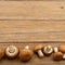 Champignon mushrooms on old wooden table. Top view.