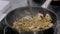 Champignon mushrooms and onions frying and sizzling in pan