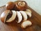 Champignons brown. Sliced mushrooms on a wooden board. Preparation of champignons.