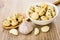 Champignons with dill on spoon, bowl with mushrooms and garlic