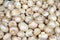 Champignons - whole uncoocked mushrooms background - top view of white field mushrooms piled for sale at the food market, ripe and