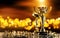 Champion golden trophy on wood table with spot lights on background