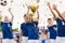 Champion youth soccer team with winning trophy. Boys football team celebrating victory in school competition