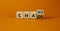 Chance or chaos symbol. Turned a wooden cube and changed the word `chaos` to `chance`. Beautiful orange background, copy space